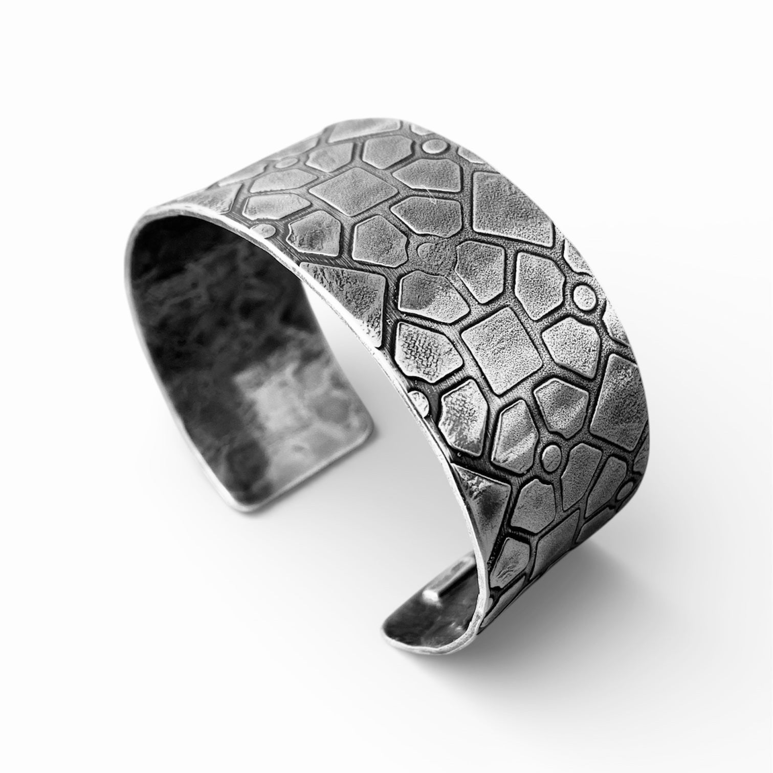 solid sterling silver 925 cuff with a geometric pattern and oxidised to bring out the pattern, handmade by Bottlebee in her Nottingham jewellery studio