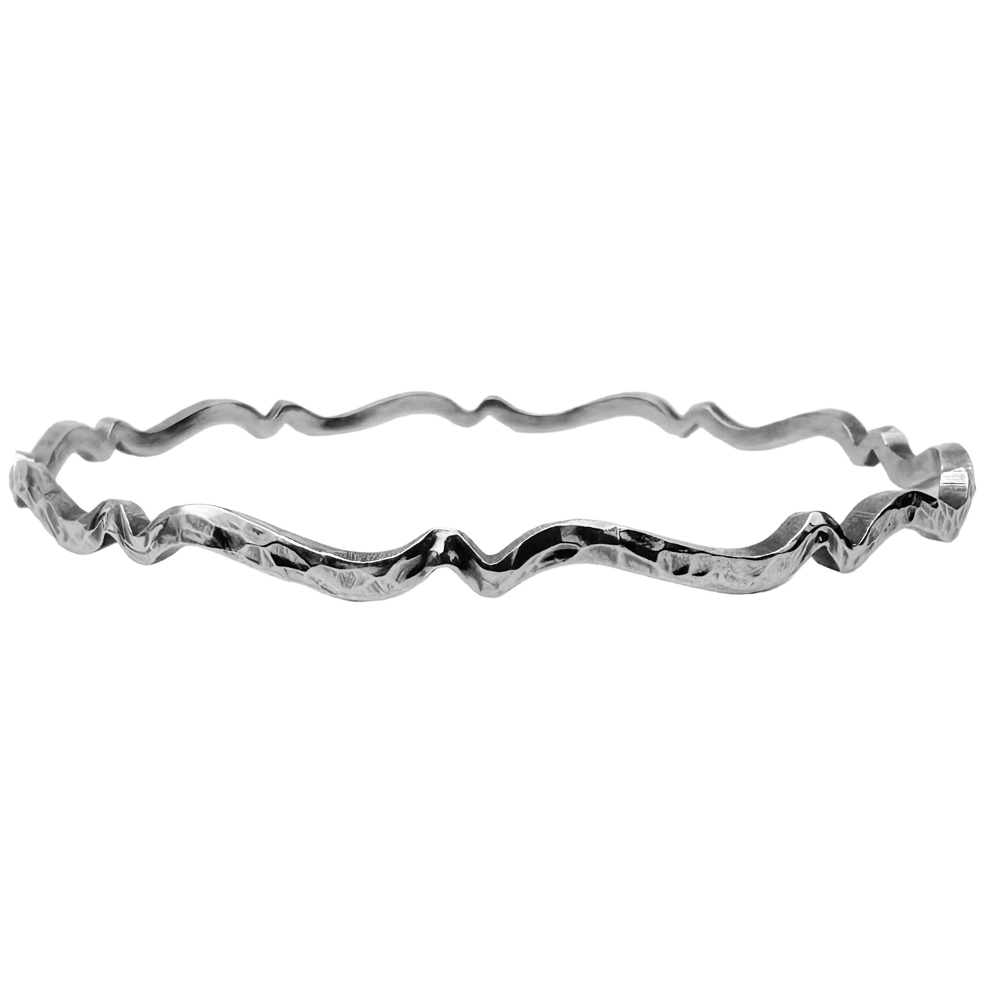 sustainable solid 925 sterling silver bangle in a wave design which has a hammered texture and oxidised to bring out the design