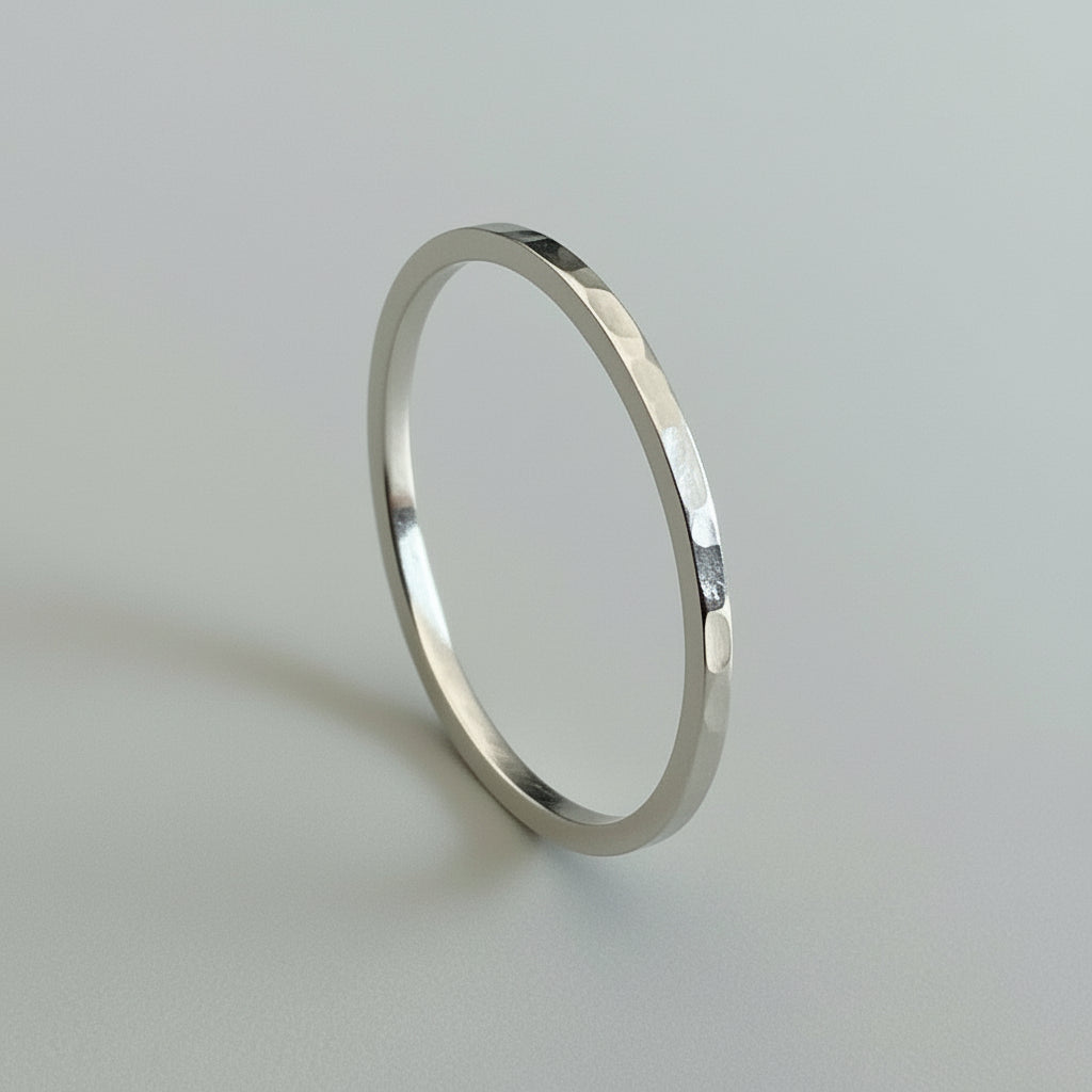 Skinny sterling silver wedding ring with a textured surface on a light gray background bespoke sustainable jewellery handmade in Nottingham by Bottlebee