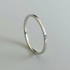 Skinny sterling silver wedding ring with a textured surface on a light gray background bespoke sustainable jewellery handmade in Nottingham by Bottlebee