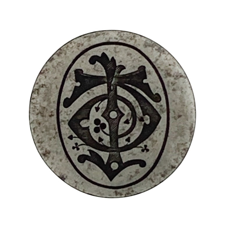 Decorative steel jewellery impression die with intricate black design on a white background