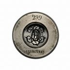 Metallic jewellery impression die with '299' and 'Hessaiguet' text on a white background