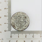 jewellery impression die for handmade jewellery in NottinghamC with engraved design next to a ruler on a white background