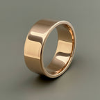 Solid 9ct gold wedding ring for men with hallmark on a light gray background. Ring is 8mm wide and handmade by Bottlebee who makes unique sustainable bespoke wedding rings and jewellery in nottingham