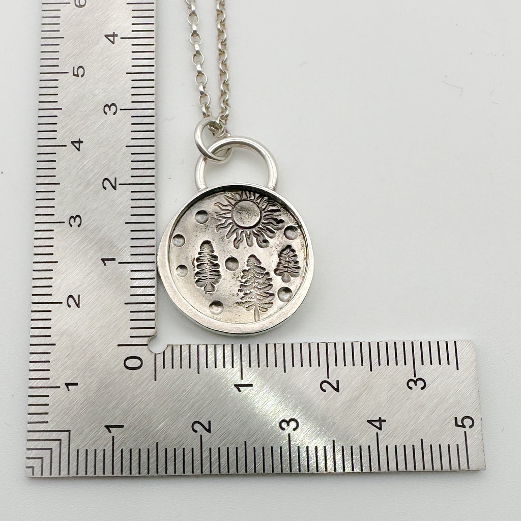 Solid silver pendant with nature-themed design on a ruler for scale handmade in Nottingham by Bottlebee sustainable
