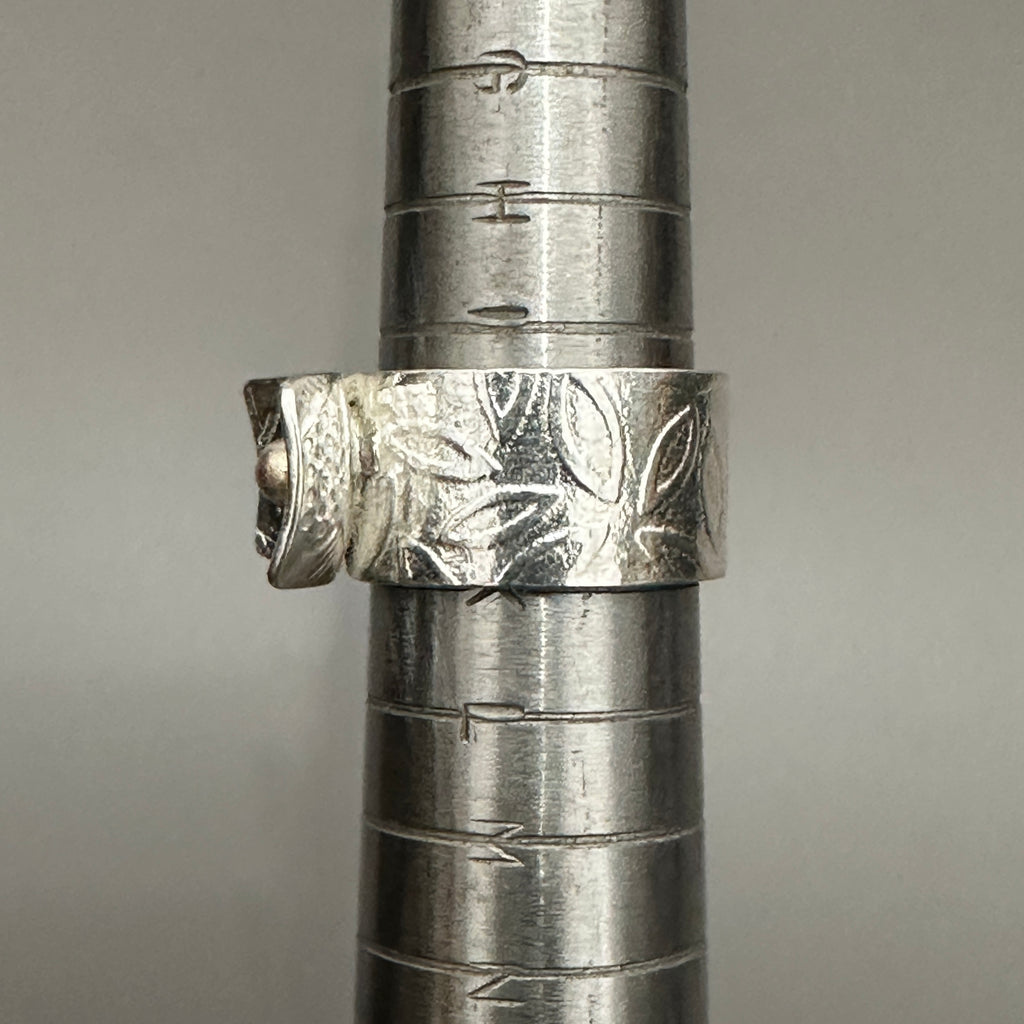 Close-up of silver ring with patterned design showing a uk size J handmade in nottingham