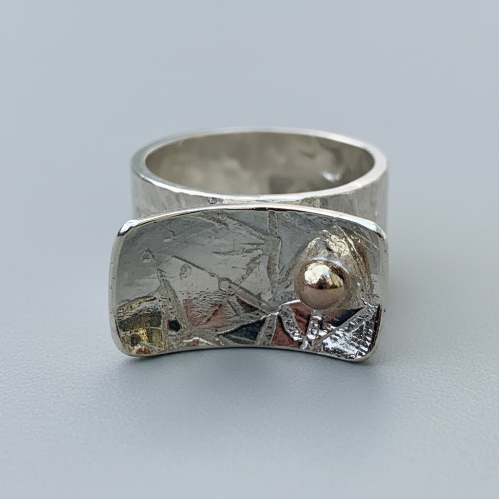 Silver ring with textured design and a gold ball handmade sustainable nottingham