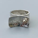 Silver ring with textured design and a gold ball handmade sustainable nottingham
