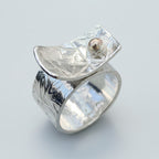 Silver ring with an 18ct ball on a light grey background handmade jewellery nottingham