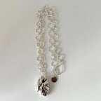 Handmade silver round link chain necklace with an anatomical heart shaped pendant on a light grey background made by Bottlebee in Nottingham