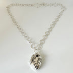 Solid silver anatomical heart pendant on a handmade chain with a handmade clasp against a white background, sustainably made by Bottlebee in Nottingham