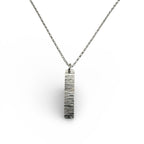 Silver necklace with a bark textured pendant on a white background sustainable made by Bottlebee in Nottingham