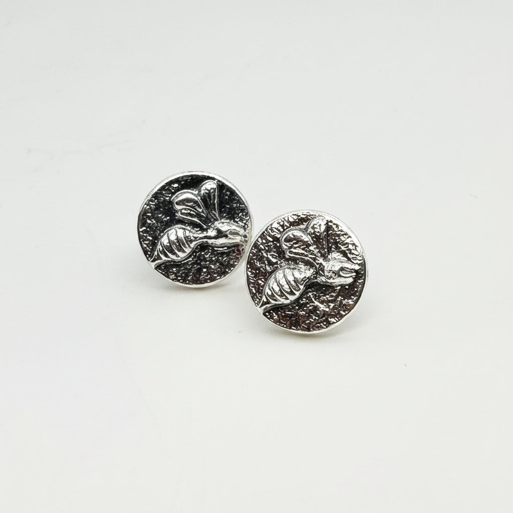 Small sterling silver round stud earrings with intricate and oxidised bee designs on a white surface handmade by Bottlebee who makes jewellery in Nottingham, commissions are welcome