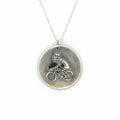 Silver necklace with a pendant featuring a flea riding a bike and wearing a top hat hamdmade by Bottlebee who makes sustainable bespoke jewellery in Nottingham on a white background
