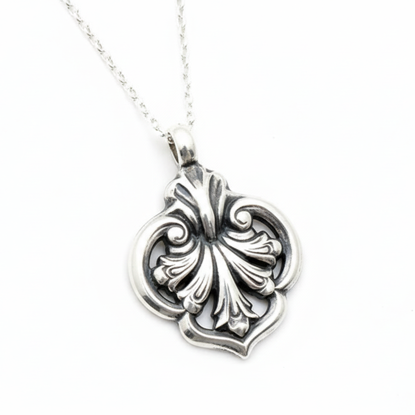 Solid sterling 925 silver wedding necklace with a black floral pendant on a light grey background sustainable jewellery nottingham