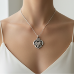 Bespoke sustainable jewellery made by Bottlebee in Nottingham, this is a silver necklace with a decorative flower fleur-de-lys pendant on a mannequin wearing a white top.