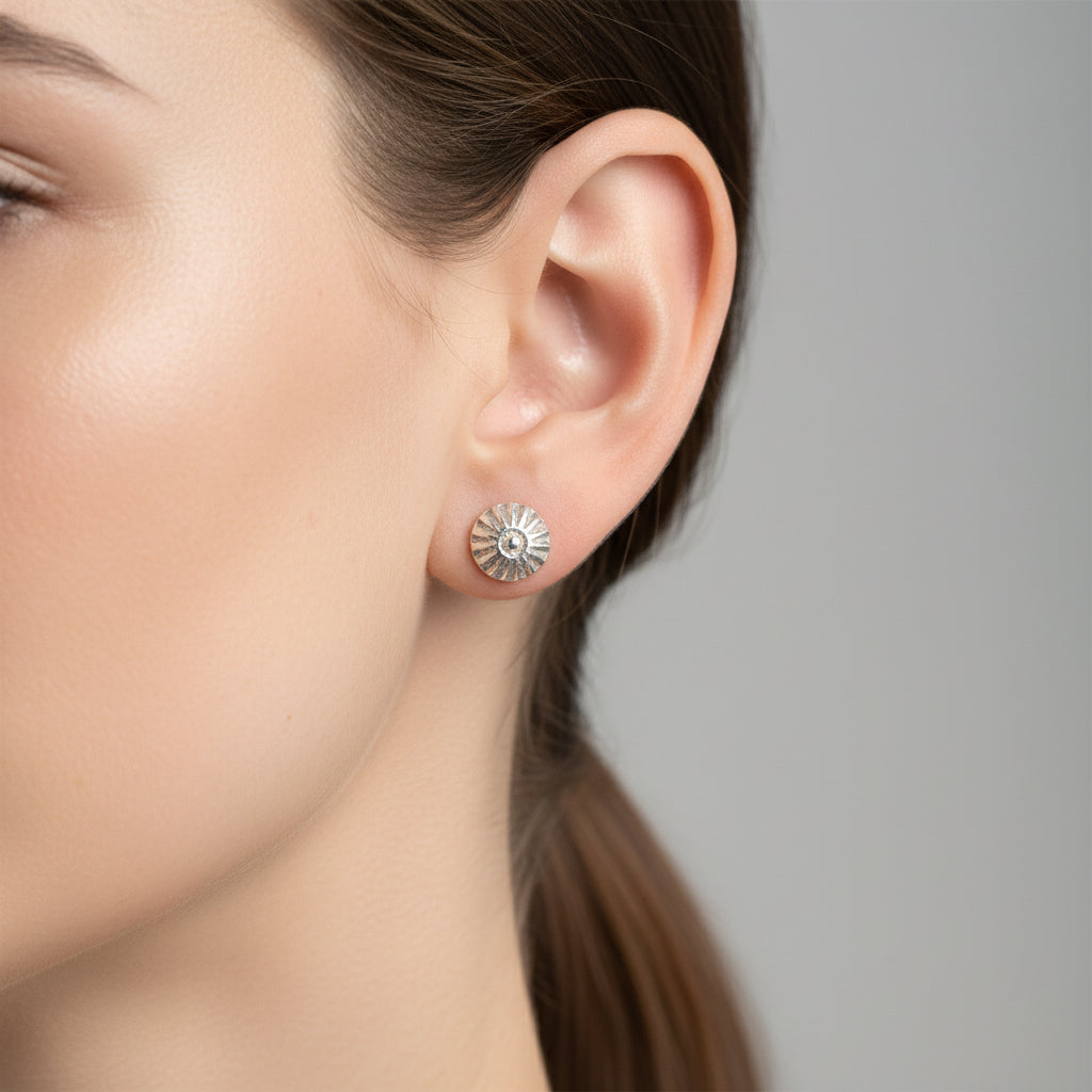 Handmade silver stud earring earring displayed on a woman with dark straight hair in a ponytail with a white background