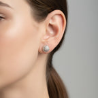 Handmade silver stud earring earring displayed on a woman with dark straight hair in a ponytail with a white background