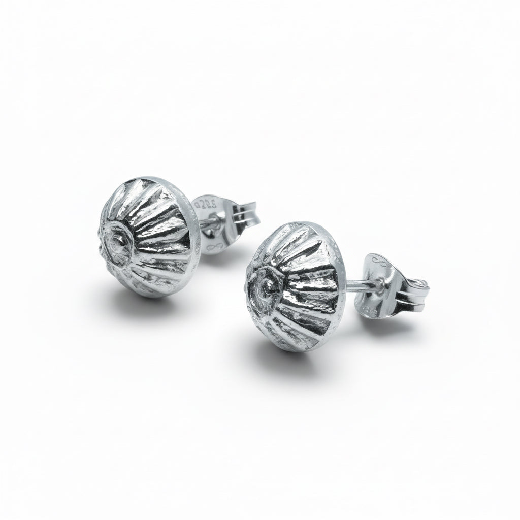 Pair of small delicate sterling silver stud earrings on a white background handmade jewellery in Nottingham 