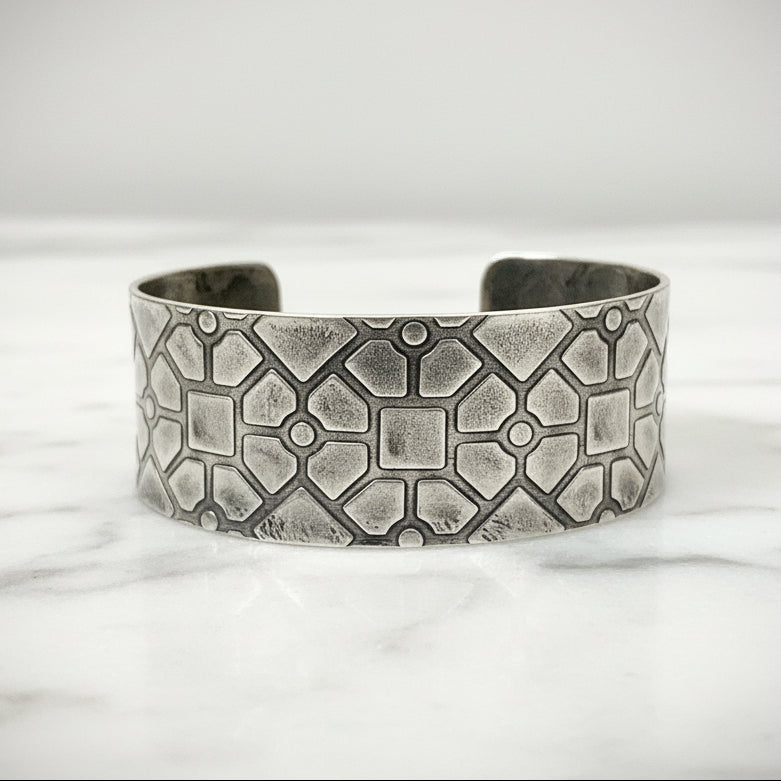 Solid sterling silver cuff with a geometric pattern and textured surface sustainably made in Nottingham by Bottlebee