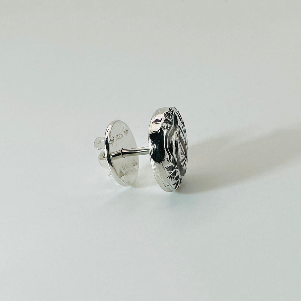 Silver personalised jewellery tie pin lapel pin shown on a finger against a white background made in Nottingham