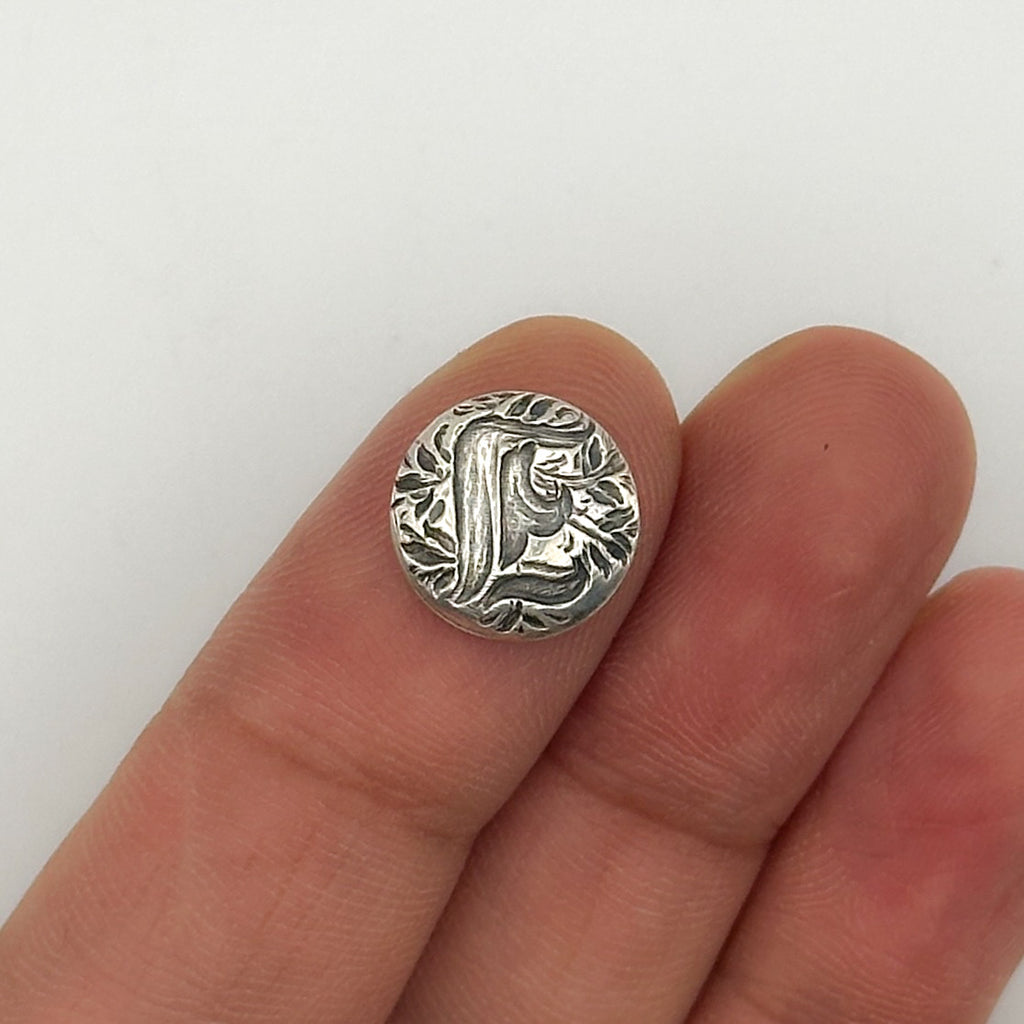 Silver personalised jewellery shown on a finger against a white background made in Nottingham