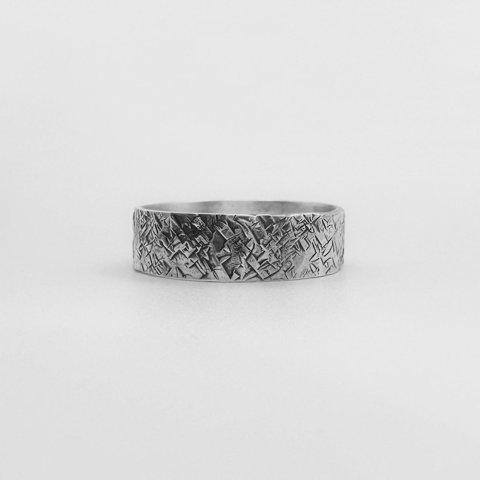 Sterling 925 sliver unique wedding band for man or woman with a hatched pattern made by Bottlebee in Nottingham with sustainable solid silver