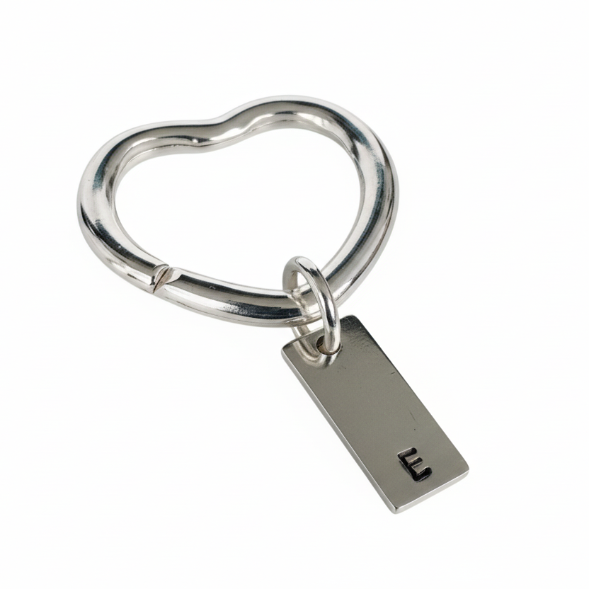 sterling silver heart keyring with a personalised hand stamped E on a 4cm rectangle tag