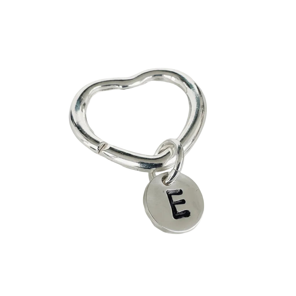 Silver heart-shaped keychain with a round tag featuring the letter 'E' on a white background