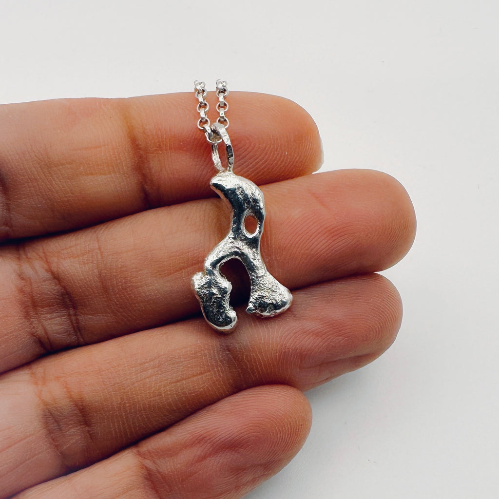 Silver necklace with a unique pendant in the shape of an elephant or hippo on a hand sustainable made in Nottingham by Bottlebee