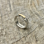 a silver and gold ring with Bottlebee stamped inside. The ring has a greek style pattern