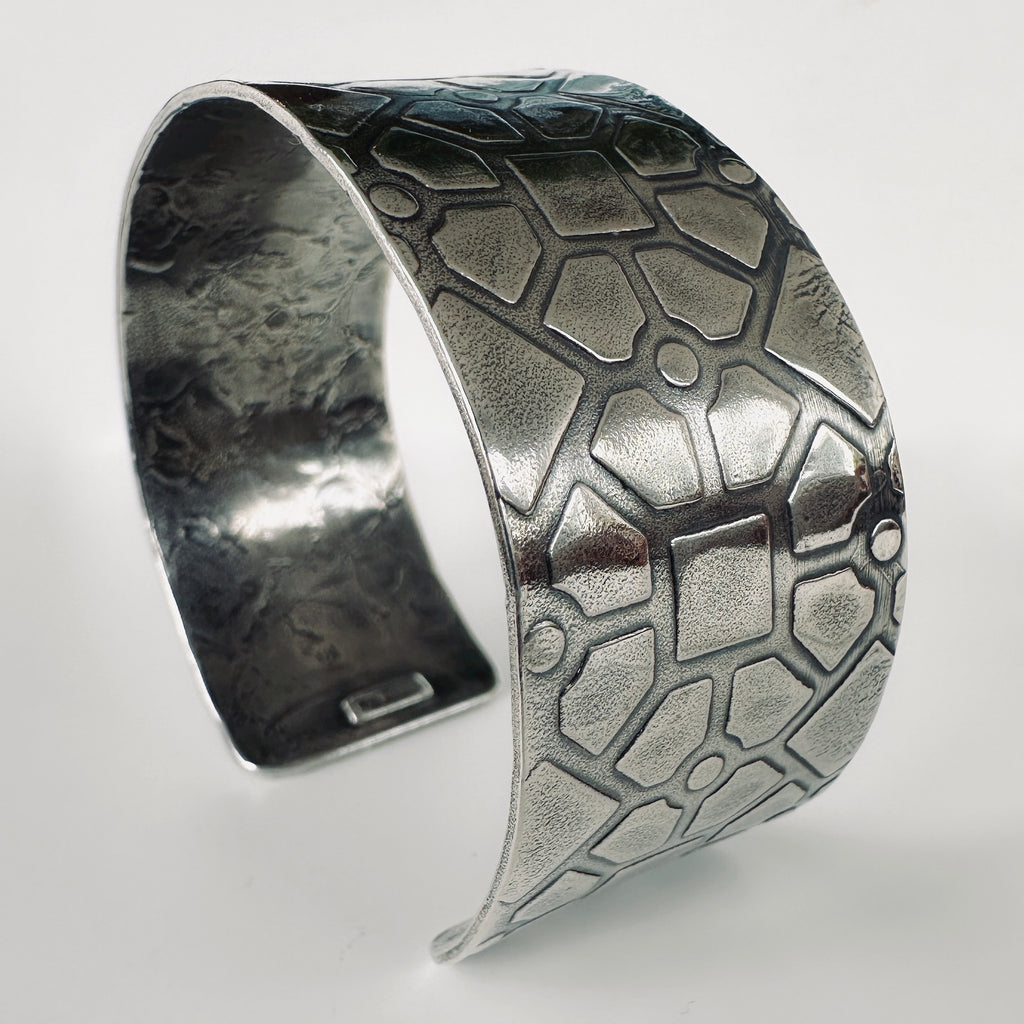 925 silver cuff bracelet with textured geometric pattern on a white background handmade by Bottlebee in Nottingham using ethical sustainable practices