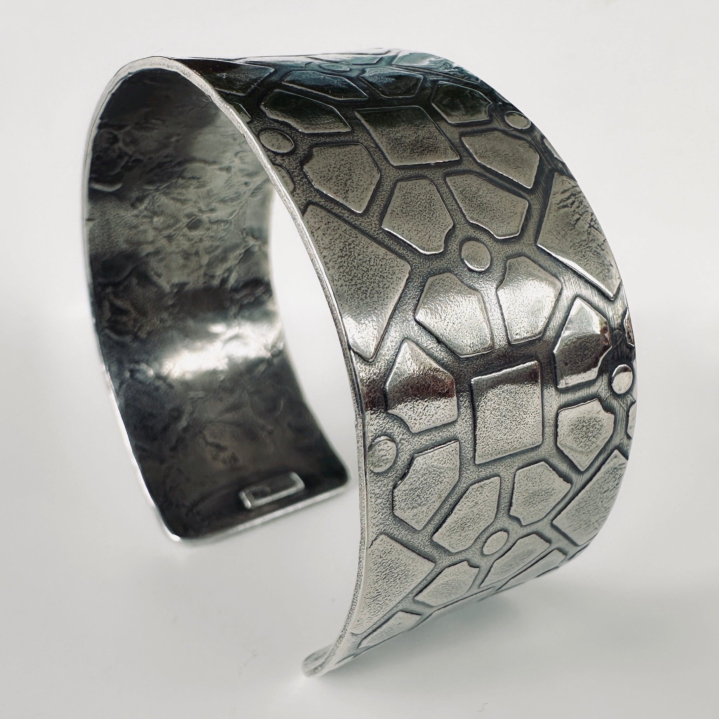 925 silver cuff bracelet with textured geometric pattern on a white background handmade by Bottlebee in Nottingham using ethical sustainable practices