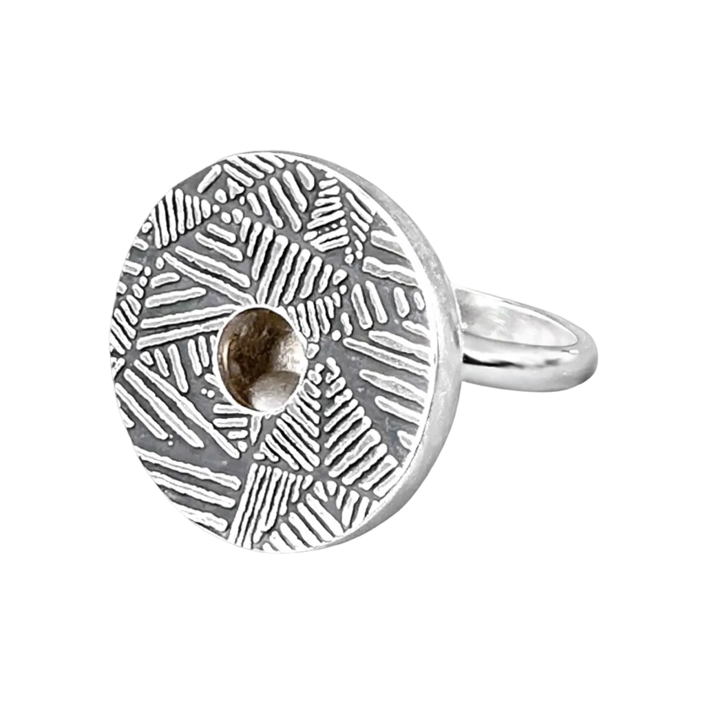 Silver kinetic ring with geometric pattern on a white background. Moving ball that makes a gently sound when moves