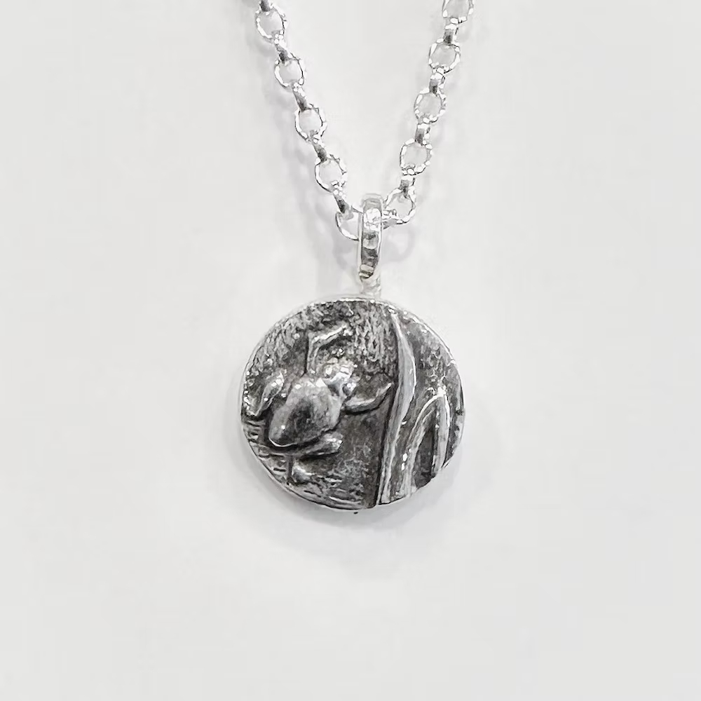 Sterling silver necklace with an oxidised frog amphibia on a white background. Bespoke jewellery handmade in Nottingham by Bottlebee