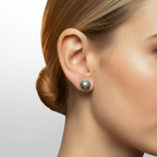 Close-up of woman’s ear wearing a silver skull themed stud earring against a light background. Handmade earring made in Nottingham by Bottlebee a small jewellery business in Nottingham, who rakes commissions