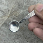 sterling silver christening baptism spoon for godson goddaughter with patterned design being held in a hand nottingham