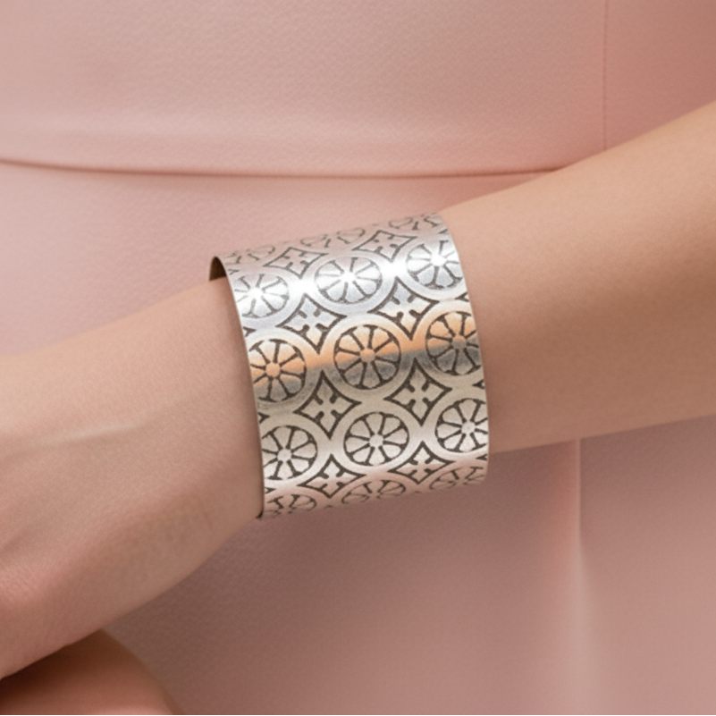 Woman in a pimk dress wearing an art deco sterling silver cuff handmade by bottlebee in Nottingham