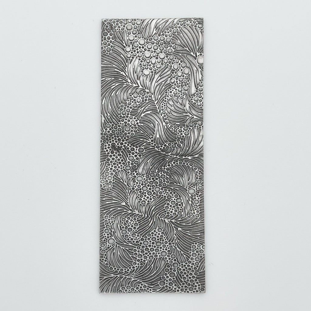 Ocean texture pattern plate to make silver and gold jeweller handmade by Bottlebee who makes sustainable bespoke jewellery in Nottingham