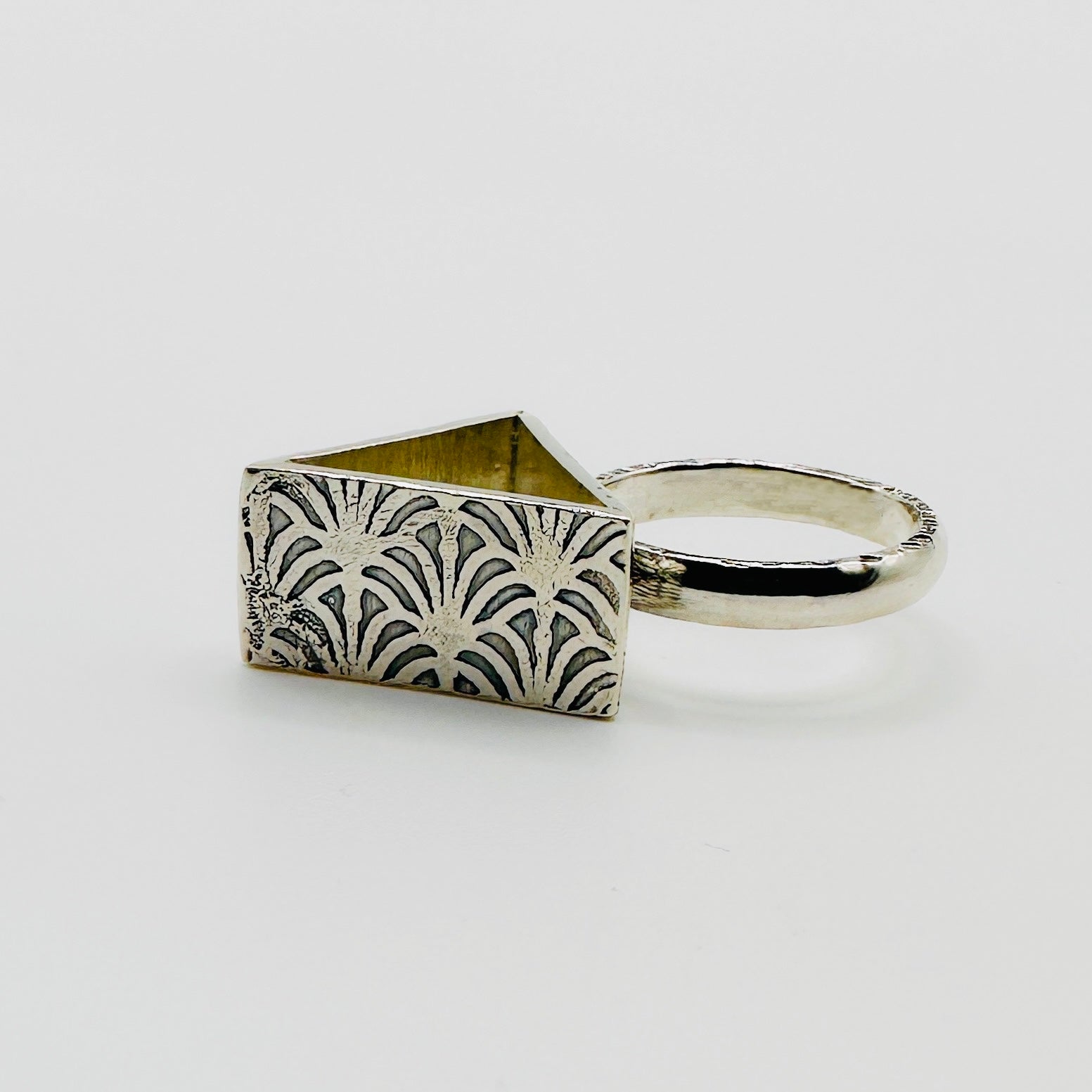 Brutalist sterling silver alternative ring with a pattern on each side, handmade sustainable by Bottlebee in Nottingham who makes bespoke jewellery