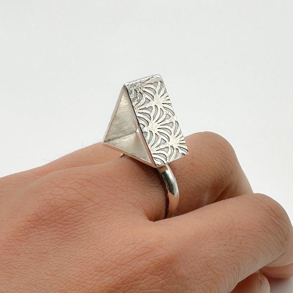 Sterling silver alternative brutalist rig with a pattern on each side, handmade sustainable by Bottlebee in Nottingham who makes bespoke jewellery