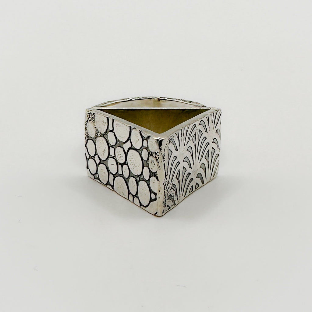Sterling silver alternative brutalist rig  triangle with pattern on each side, handmade sustainable by Bottlebee in Nottingham who makes bespoke jewellery