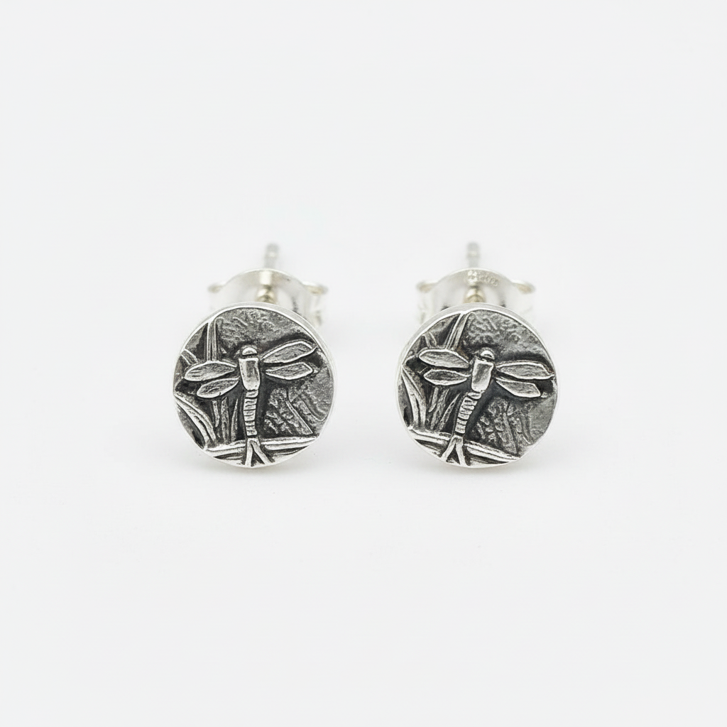 A pair of sliver stud earrings with a dragonfly design, jewellery is handmade by Bottlebee in Nottingham