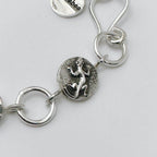 Close-up of a silver bracelet with gecko charm on a light grey background made in Nottingham by Bottlebee who mades jewellery that is sustainable