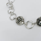 Close-up of a silver bracelet with dragonfly charm on a light grey background made in Nottingham