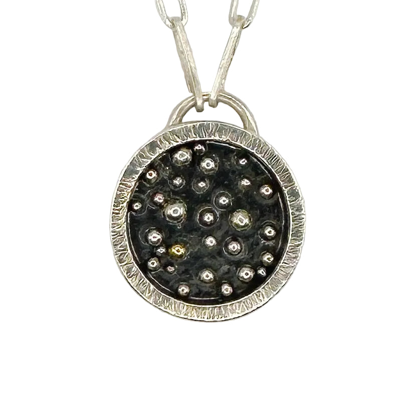 close up of silver and gold pendant with a paperclip chain made with sustainable practices in Nottingham by Bottlebee