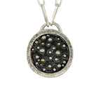 close up of silver and gold pendant with a paperclip chain made with sustainable practices in Nottingham by Bottlebee