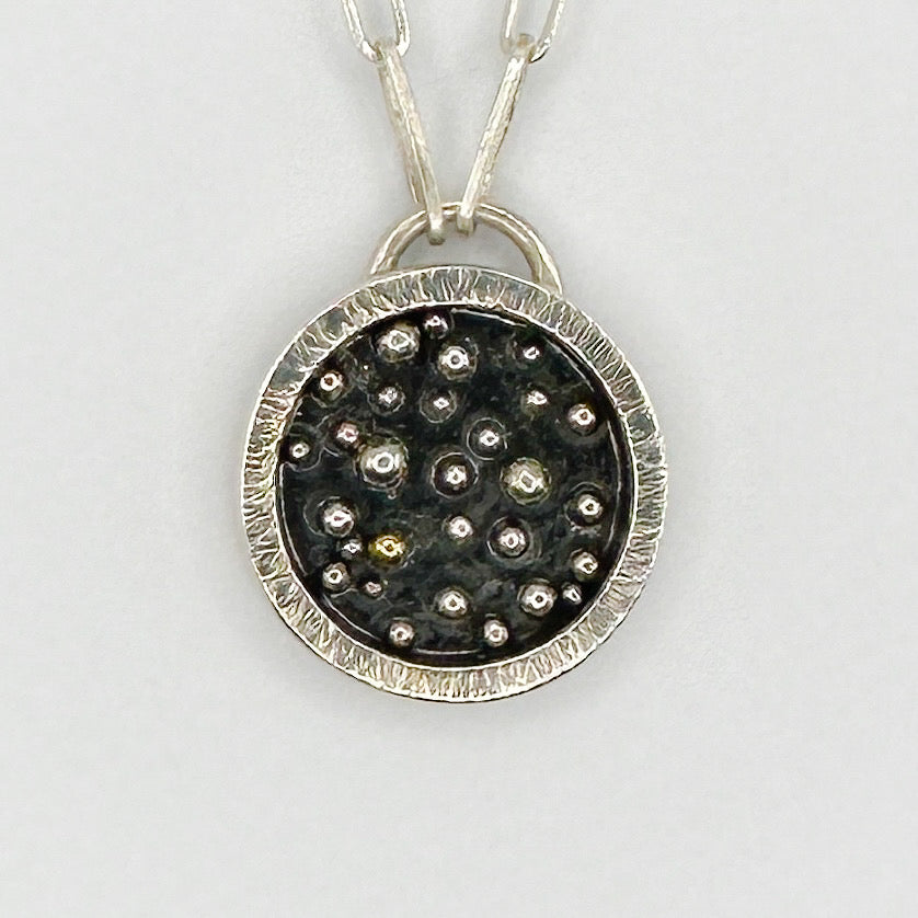 Close up of a silver and gold handmade necklace sustainable made by Bottlebee in Nottingham