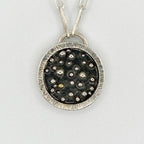 Close up of a silver and gold handmade necklace sustainable made by Bottlebee in Nottingham