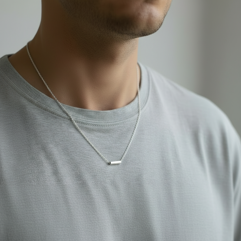man in a grey tshirt wearing a handmade sterling silver necklace made by a small one woman business in Wollaton Nottingham